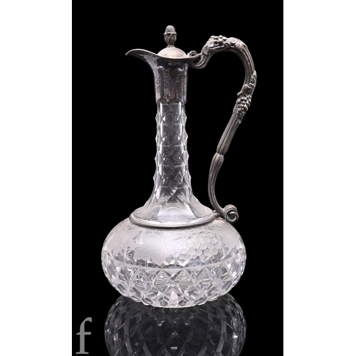 1181 - A late 19th Century to early 20th Century clear crystal claret jug, the compressed ovoid body cut wi... 