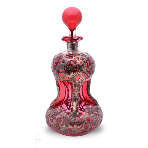 1186 - An early 20th Century cranberry glass Scrooge decanter with white metal pierced foliate overlay, glo... 