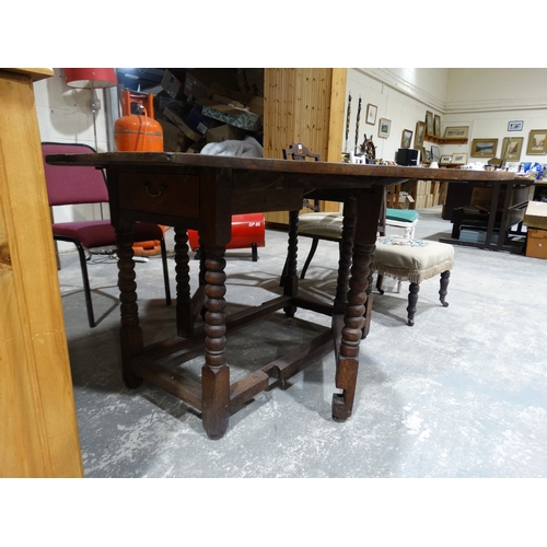 256 - An Antique Oak Drop Leaf Table On Block & Turned Supports, 50