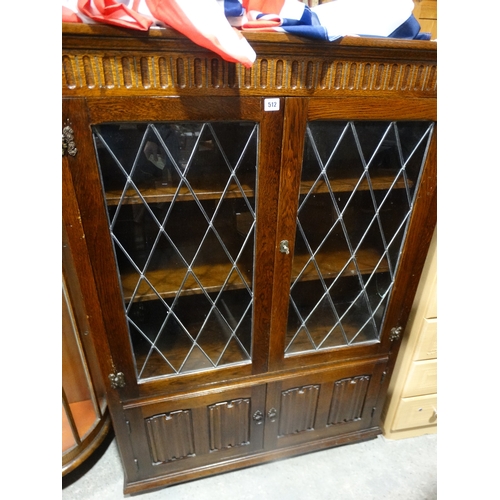 512 - A Polished Oak Linen Fold Four Door Bookcase Cabinet