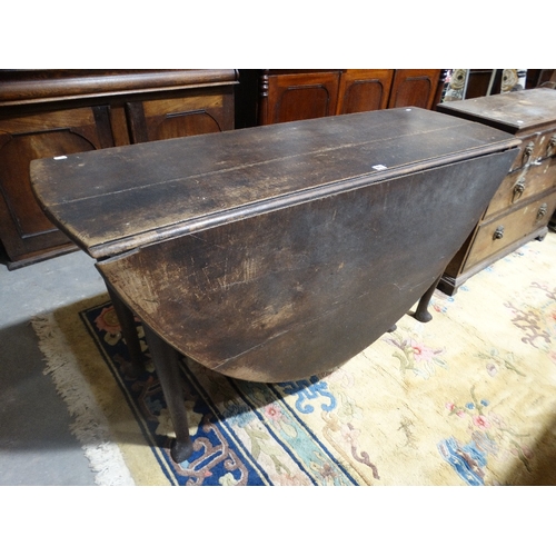 402 - An Antique Oak Drop Leaf Table On Pad Supports