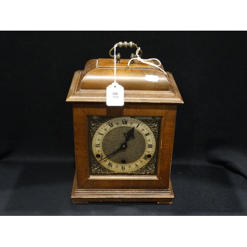 87 - A Polished Oak Encased Bracket Clock With Circular Silvered Dial