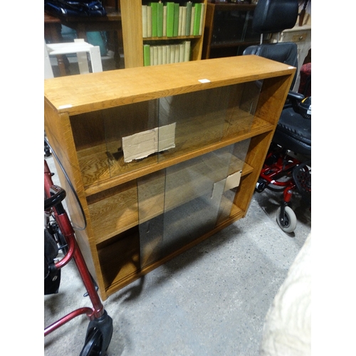 451 - An Early 20th Century Light Oak Finish Bookcase With Sliding Glass Doors