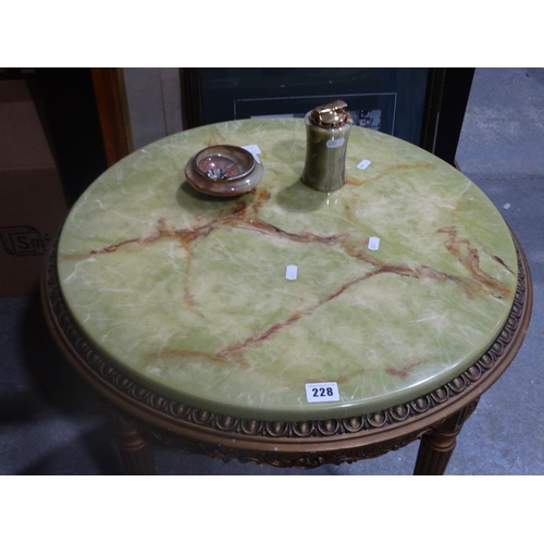 228 - An Onyx Effect Circular Top Table With A Table Lighter And Ashtray