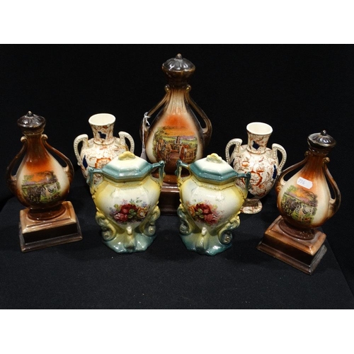 31 - An Edwardian Pottery Garniture Set, Together With Two Further Pairs Of Vases