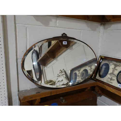 283 - An Oval Copper Framed Wall Mirror