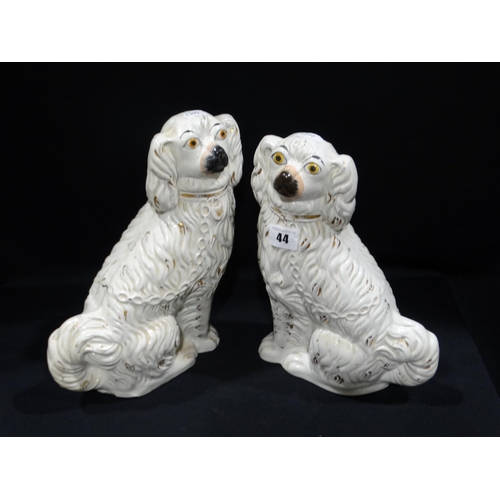 44 - A Pair Of Staffordshire Pottery White Seated Dogs