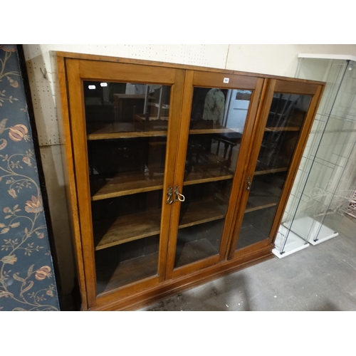 557 - An Edwardian Three Door Bookcase Cabinet