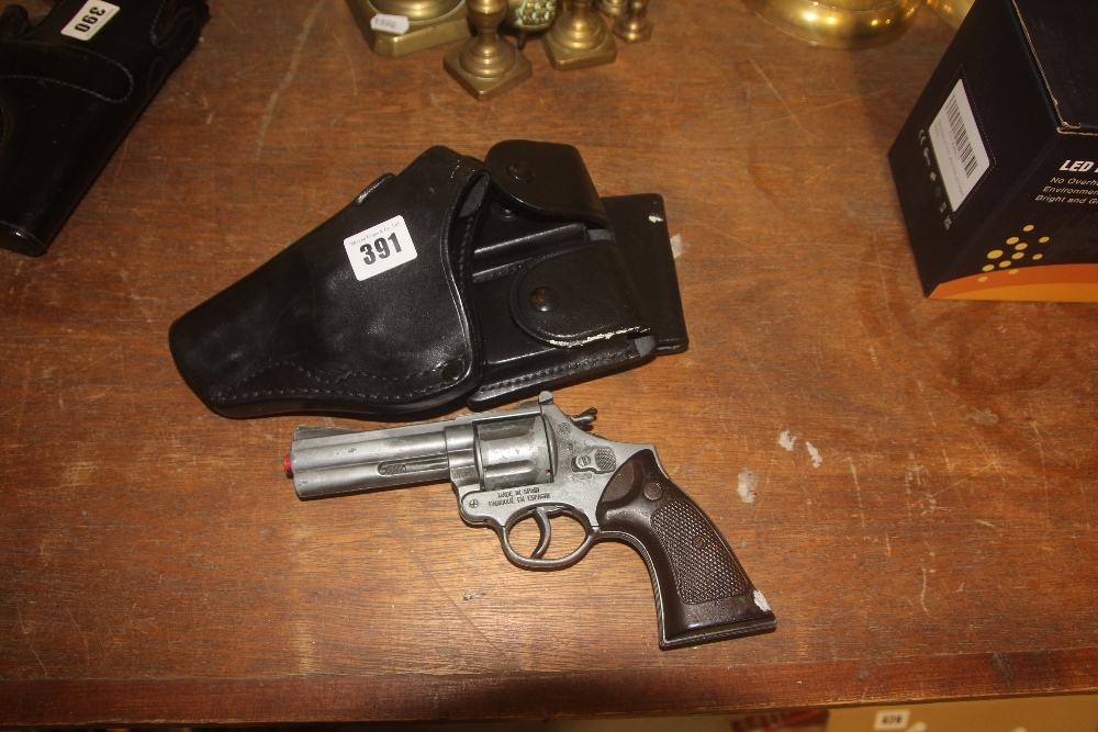 A Leather GP100 Left Handed Revolver Holster, With Toy Cap Gun