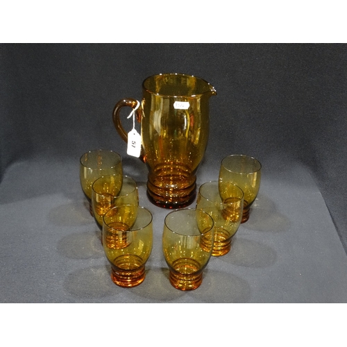 57 - An Amber Tinted Glass Cordial Set