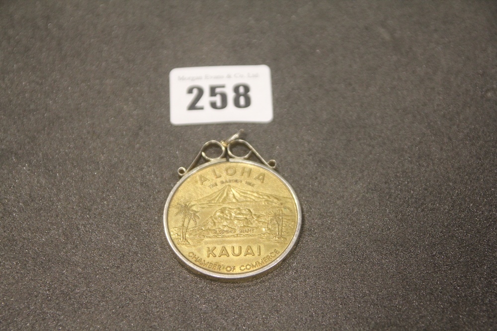 A Hawaii Dollar Coin Within A Silver Mount