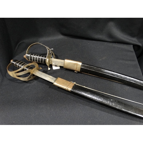 187 - A Pair Of English Pattern Cavalry Swords In Black Leather Scabbards