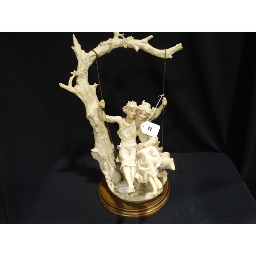 11 - A Capodimonte Type Sculpture Of Couple On A Swing