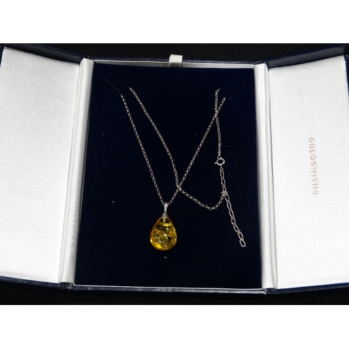 an-amber-silver-pendant-on-a-silver-chain