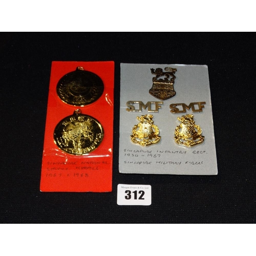 312 - A Group Of Singapore Military Badges & Two National Service Medals