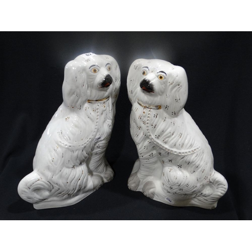 62 - A Pair Of Staffordshire Pottery White Seated Dogs