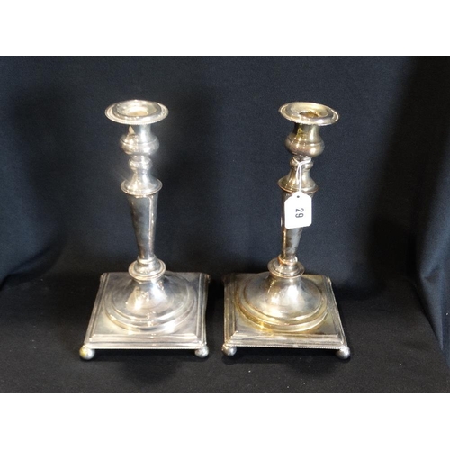 29 - A Pair Of Square Based Sheffield Plate Candlesticks On Bun Feet, 12