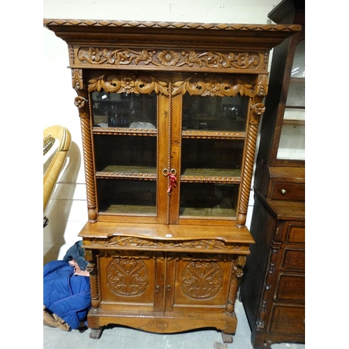 598 - A Carved Continental Bookcase Cupboard With Upper Glazed Doors & Carved Base Cupboards