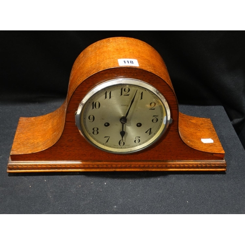 118 - A Polished Oak Encased Mantle Clock With A Circular Silvered Dial