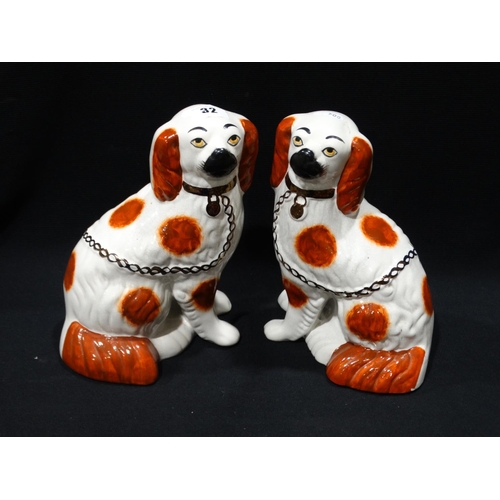 32 - A Pair Of Staffordshire Pottery Red & White Seated Dogs