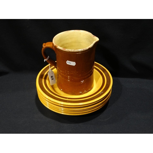 62 - A Slip Glazed Milk Jug, Together With A Set Of Six Stoneware Plates