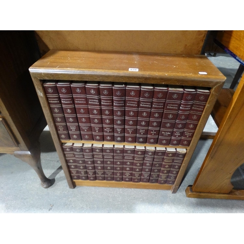 A Set Of Encyclopedia Britannica Within A Bookcase