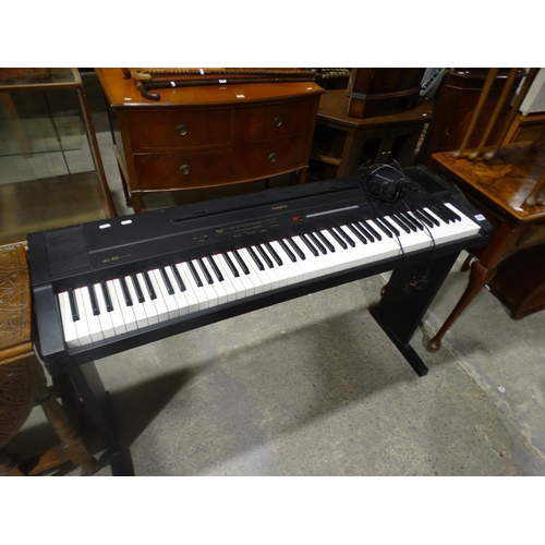 A Roland EP85 Digital Piano & Stand
