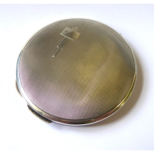 207 - AN ART DECO SILVER CIRCULAR COMPACT
With engine turned decoration, geometric initials cartouche and ... 