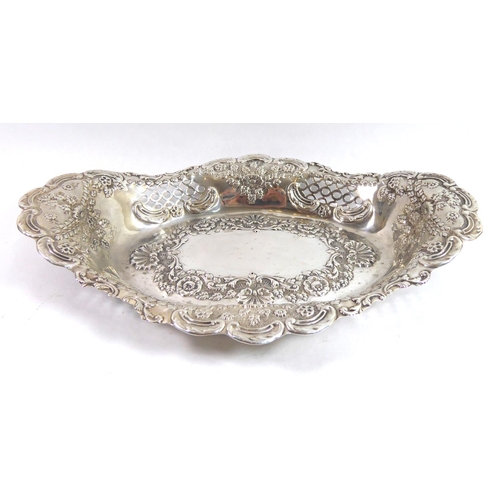 266 - WILLIAM J HOLMES, A LATE VICTORIAN SILVER CAKE BASKET
With floral repousse decoration and pierced si... 