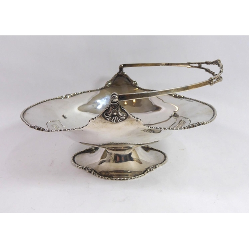 270 - JOSIAH WILLIAMS & CO., AN EARLY 20TH CENTURY SILVER CAKE BASKET
Having a gadrooned edge broken up by... 