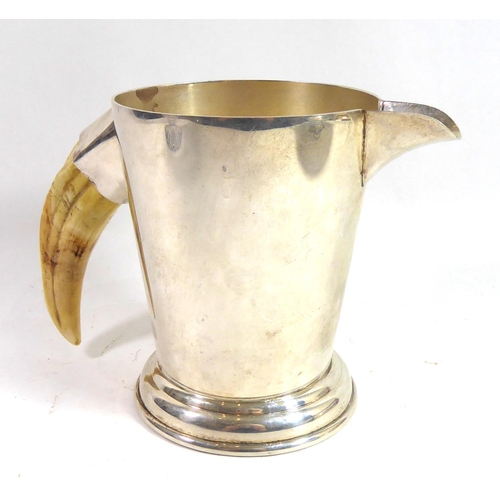 271 - PHV & CO., A 20TH CENTURY WHITE METAL PITCHER
The tapering form body having a boars tusk handle, sta... 