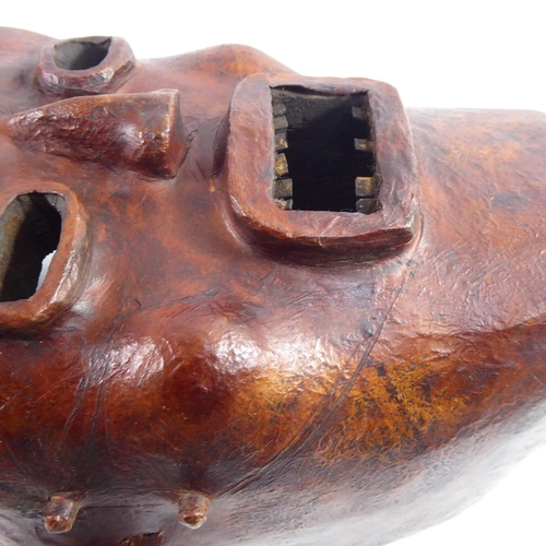 379 - AN AFRICAN CARVED WOOD AND ANTELOPE SKIN TRIBAL FACE MASK
From the Widekum Cross River, Region of Ca... 