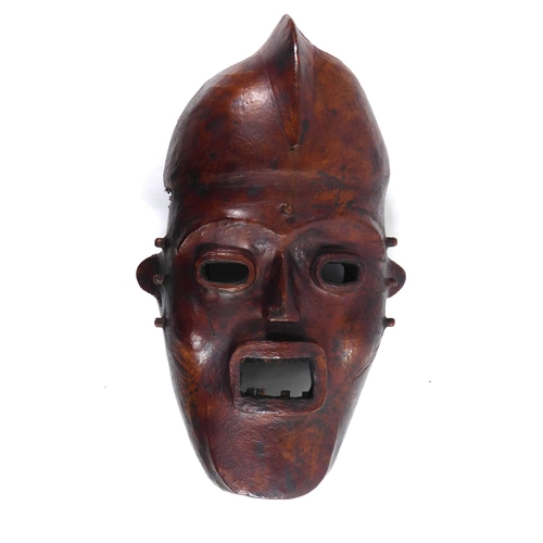 379 - AN AFRICAN CARVED WOOD AND ANTELOPE SKIN TRIBAL FACE MASK
From the Widekum Cross River, Region of Ca... 