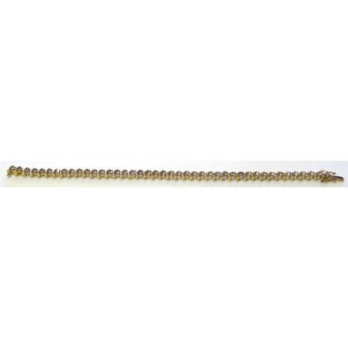 74 - AN 18CT GOLD AND DIAMOND TENNIS BRACELET
The single row of round cut diamonds in a half twist mount.... 