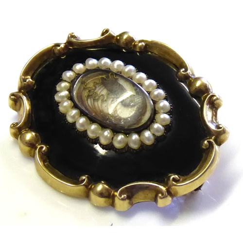 84 - A VICTORIAN YELLOW METAL, SEED PEARL AND BLACK ENAMEL MOURNING BROOCH 
Rectangular form, with scroll... 