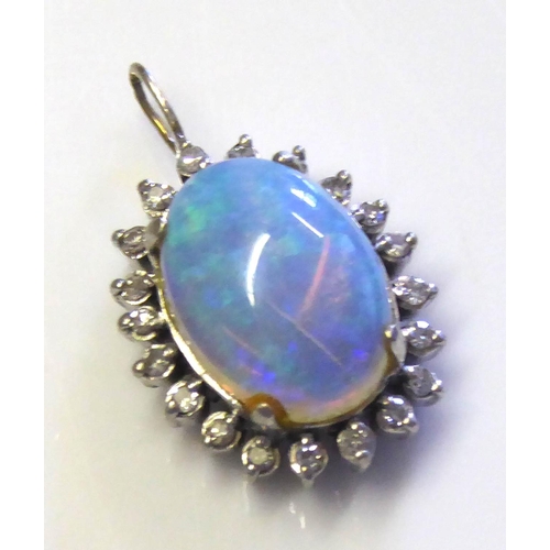 85 - A WHITE METAL, OPAL AND DIAMOND PENDANT
Having a single cabochon cut opal edged with diamonds.
(appr... 