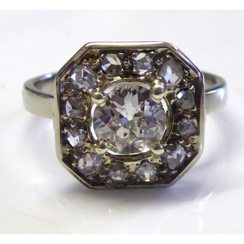 86 - A FRENCH ART DECO 18CT WHITE GOLD AND DIAMOND RING
Having a single round cut diamond edged with diam... 