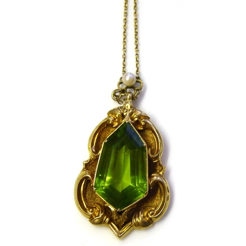 87 - A VICTORIAN YELLOW METAL, PERIDOT AND SEED PEARL PENDANT
Having a lozenge form stone in a scrolled m... 