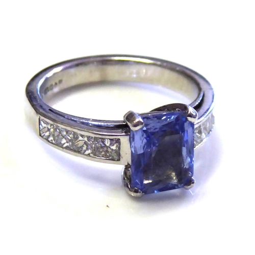 96 - A PLATINUM, SAPPHIRE AND DIAMOND RING
The baguette cut sapphire in a raised mount with Princess cut ... 