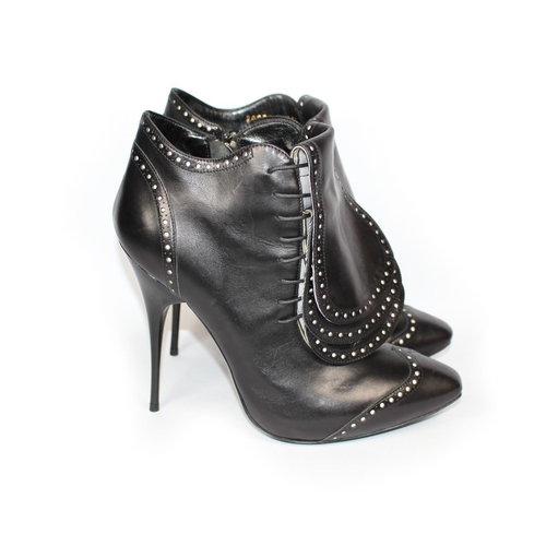 177A - ALEXANDER MCQUEEN, BLACK LEATHER ANKLE BOOTS  
With side zip and three front leather flaps covering ... 