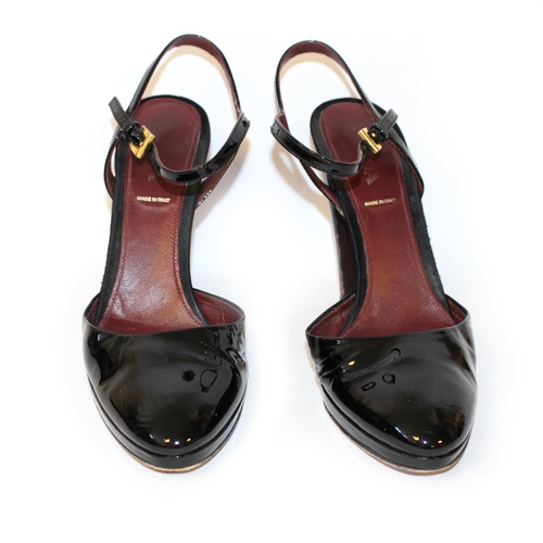 178A - PRADA, BLACK PATENT LEATHER HEELS
The heel strap with gilt metal buckles (size 39.5).
(heel 11cm)