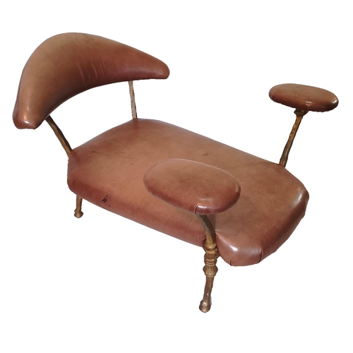 145 - MARK BRAZIER-JONES, B. 1956, TAN LEATHER STUDY CHAIR 
On bronzed steel supports with hoof feet.
(100... 