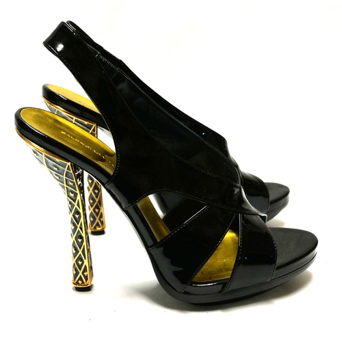 182 - BALENCIAGA, A PAIR OF BLACK PATENT LEATHER SLINGBACKS
With gilt enamelled heels (size 40).

Conditio... 