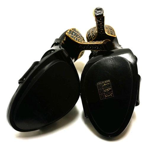 182 - BALENCIAGA, A PAIR OF BLACK PATENT LEATHER SLINGBACKS
With gilt enamelled heels (size 40).

Conditio... 