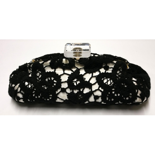 422 - CHANEL, A BLACK AND WHITE COTTON AND SATIN FLORAL LACE LARGE FRAMED CLUTCH
With lucite monogrammed c... 