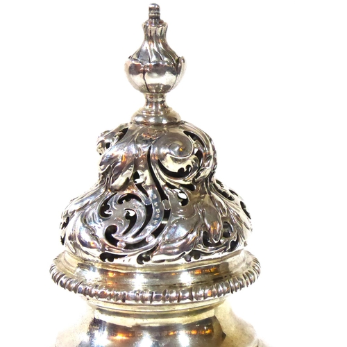 412 - ROBERT TYRILL, A RARE GEORGE III SILVER SUGAR CASTER 
Having a scrolled and pierced dome lid and roc... 