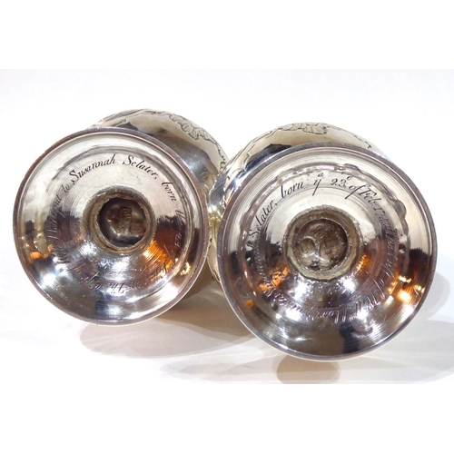 414 - A PAIR OF GEORGE II SILVER CASTERS
Having pierced dome form lids with pineapple finials and scrolled... 