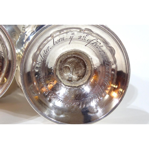 414 - A PAIR OF GEORGE II SILVER CASTERS
Having pierced dome form lids with pineapple finials and scrolled... 