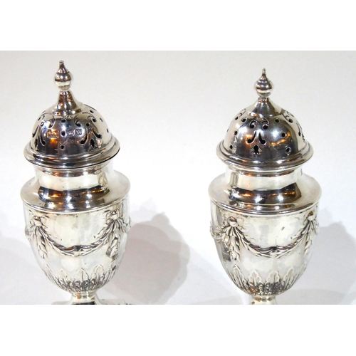 416 - A PAIR OF VICTORIAN SILVER CASTERS
Classical form with embossed swags and bows, hallmarked Atkin Bro... 