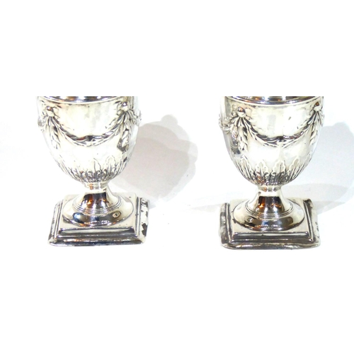 416 - A PAIR OF VICTORIAN SILVER CASTERS
Classical form with embossed swags and bows, hallmarked Atkin Bro... 